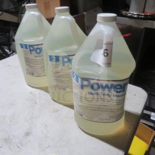 Three gallons of Power Up Multi-Temp Machine Cleaner, with labels indicating usage instructions and safety precautions.
