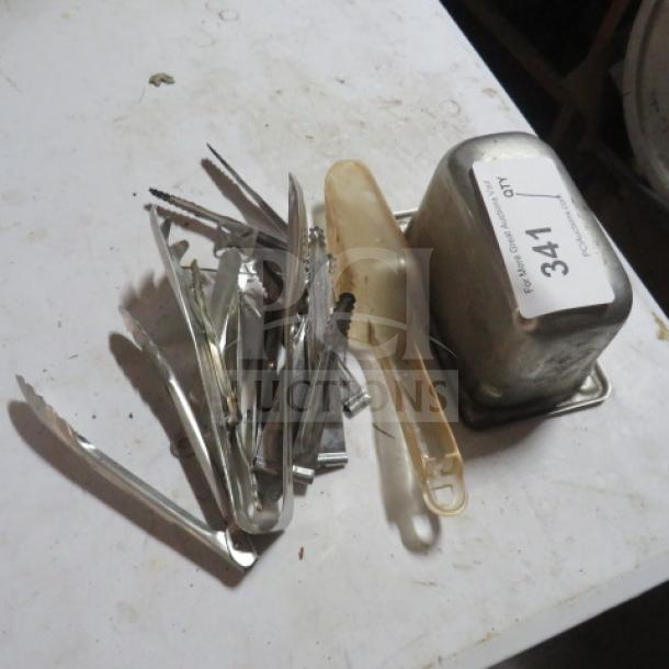 One Lot of Miscellaneous items including metal utensils and a plastic scoop, labeled "341". Mixed condition.