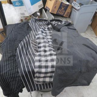 Assorted aprons, various striped patterns, gently used condition, includes black, gray, and checkered designs.