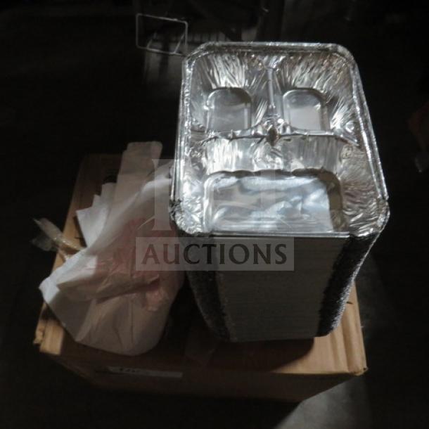 A stack of aluminum trays on a cardboard box, surrounded by white paper products.