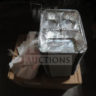 A stack of aluminum trays on a cardboard box, surrounded by white paper products.