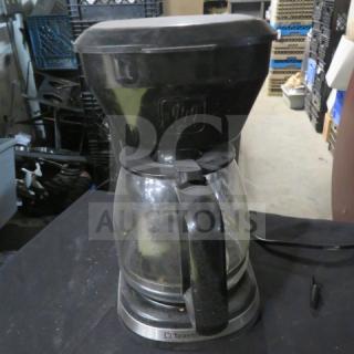 Toastmaster coffee brewer in used condition, featuring a glass carafe and black plastic components.