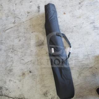 Black banner print holder with handle and zippered carry case on concrete floor.