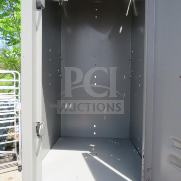 Global metal locker system with 3 lockers, dimensions 12"x15"x78". Used condition, sturdy construction.