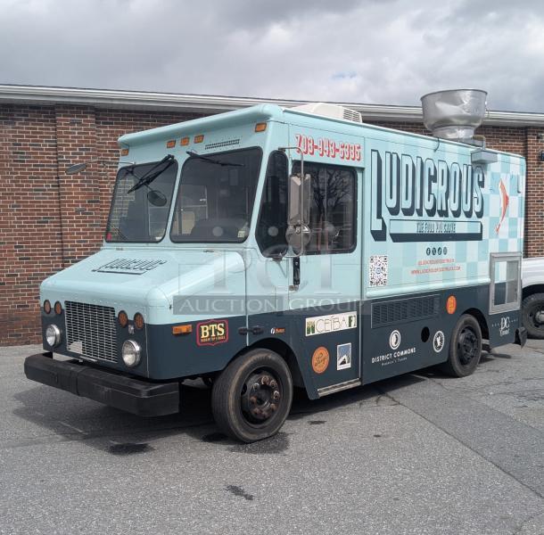 2002 Freightliner MT45 Ludicrous wrapped 18' food truck with propane hookup, grease hood, fryer, griddle, grill, refrigeration, and serving window.