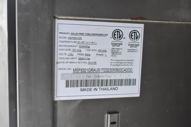 Label on salad prep table refrigerator, model MSF8301GR. Specifications: temp range 33-45°F, refrigerant R290, volts 115V. Made in Thailand.