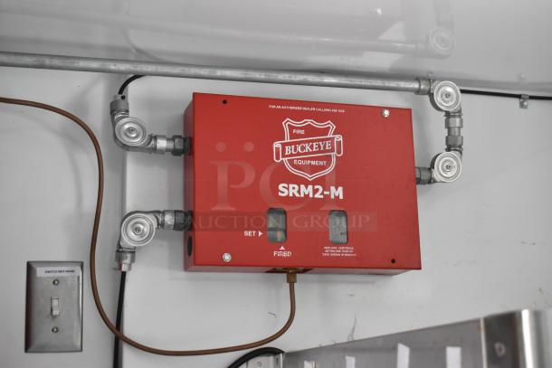 Red Buckeye SRM2-M fire suppression system in 2002 Freightliner MT45 food truck. Safety feature for kitchen equipment.