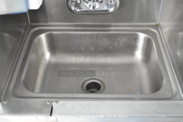 Stainless steel kitchen sink with drain in a 2002 Freightliner MT45 food truck.