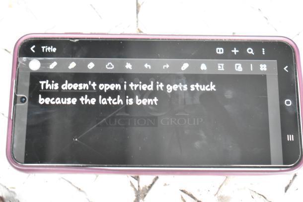 A smartphone displaying a message: "This doesn't open, the latch is bent" on its screen.