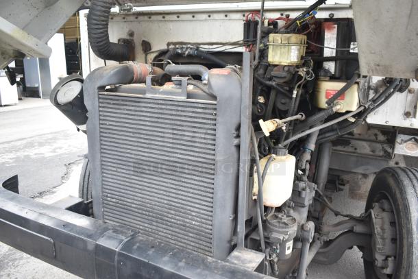 Engine view of a 2002 Freightliner MT45 food truck, showing detailed engine components and wiring.