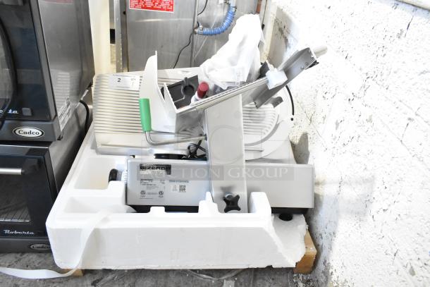 2023 Bizerba GSP HD commercial meat slicer, 120V, 1 phase. New in packaging, stainless steel, with visible brand label.