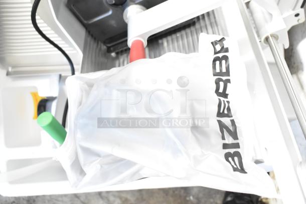 2023 Bizerba GSP HD meat slicer, with visible brand logo on a white cover, in excellent condition.