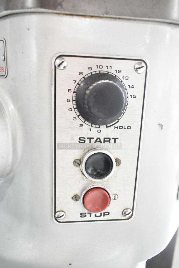 Hobart P660 mixer control panel. Features timer knob, start button, and stop button. Sturdy metal construction.