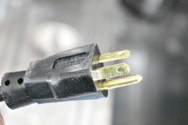 Close-up of a power plug for the Frosty Factory 217W frozen cocktail machine, brand new with scratch and dent condition.