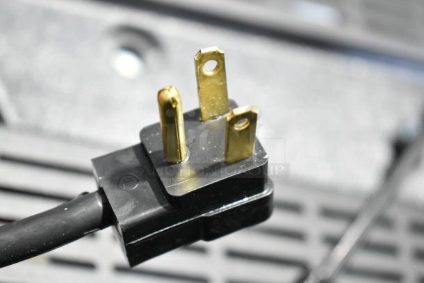 Power cord plug of a Beverage Air UCR32AHC-ADA commercial cooler, showing the three-prong configuration.