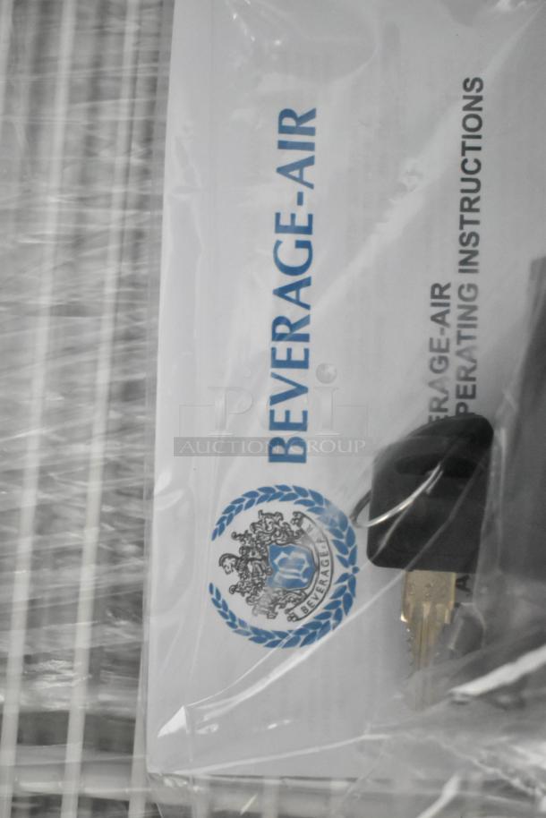 Beverage Air MT23-1 B 18 merchandiser keys and manual, in original packaging, for a black refrigerated glass door unit.