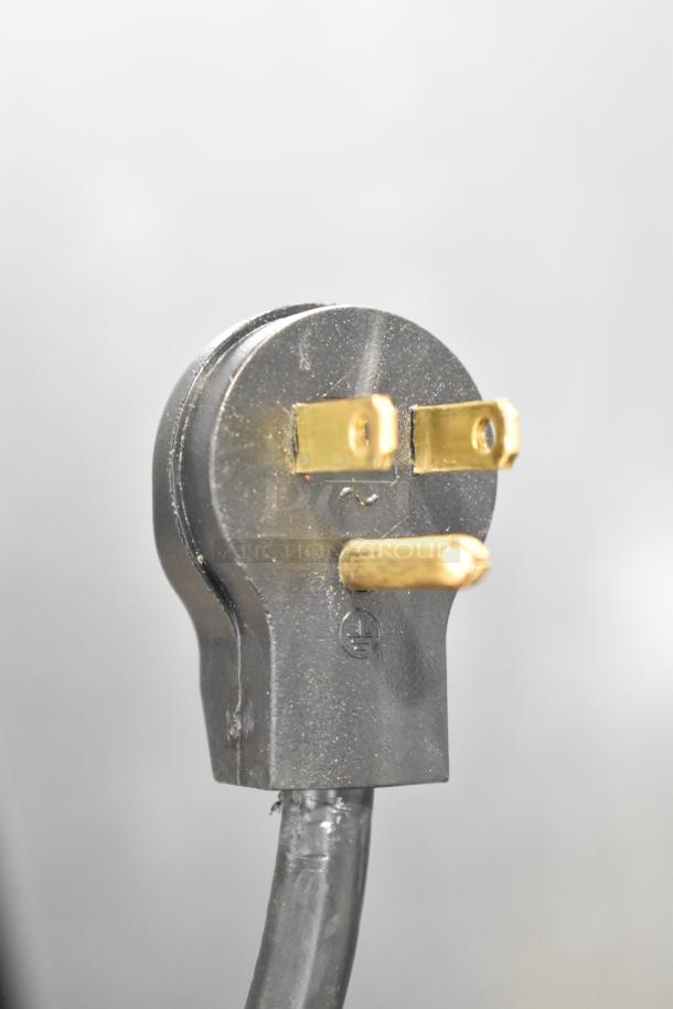 Close-up of a black three-prong plug for the Beverage Air MT23-1 B 18 refrigerated merchandiser.