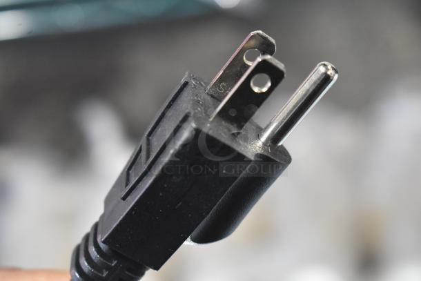 Close-up of a three-prong plug for the 2025 Avantco 177BW32 Stainless Steel 32 Bun Warmer, 120 Volts, 1 Phase.