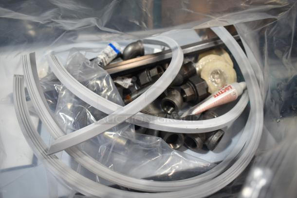 Parts and accessories for Delfield N8130BP cold food well, including tubing and connectors, in original packaging.