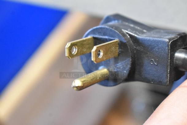 Close-up of a three-prong power plug for the 2024 Delfield N8130BP Cold Food Well, 120 volts, 1 phase.