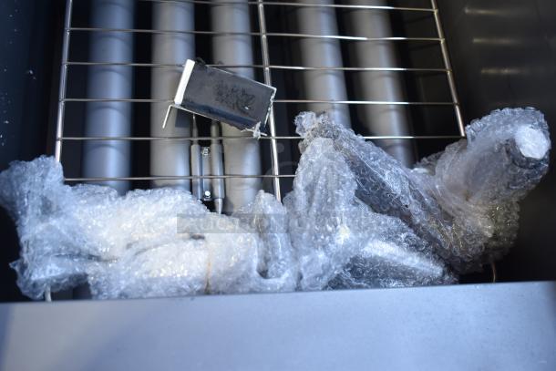 Brand new 2024 Avantco 177FF100L stainless steel floor fryer, 150,000 BTU, with bubble wrap protection.