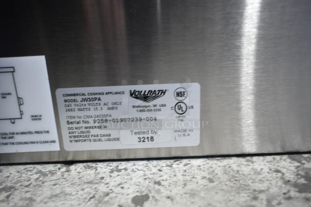 Close-up of the label on a new Vollrath JW30PA countertop cheese melter, 240V, showing model, serial number, and certifications.