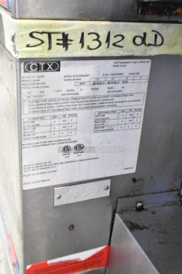 Middleby Marshall CTX DZ33T stainless steel conveyor pizza oven with operational details label, on commercial casters.