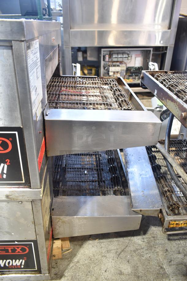 Two 2021 Middleby Marshall CTX DZ33I stainless steel conveyor pizza ovens on commercial casters. Electric, 208V, tested and working.