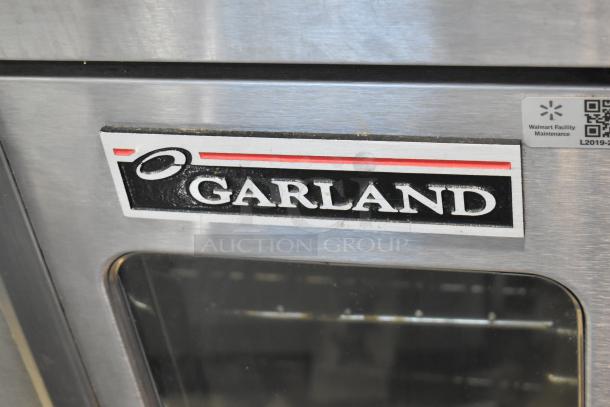 Garland Master 200 convection oven, full size, view-through doors, thermostatic controls, metal legs, brand logo visible.