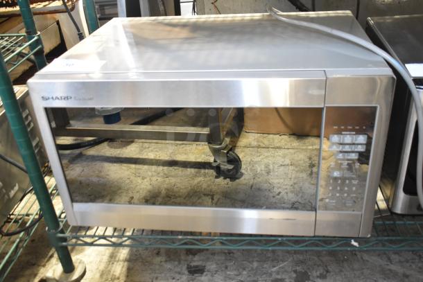 Sharp R-551ZM microwave oven with plate, 120V, 1 phase. Features control panel and stainless steel finish, good condition.