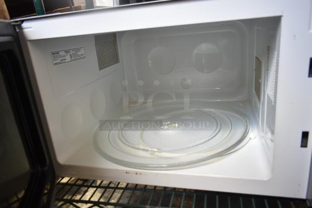 Sharp R-551ZM Microwave Oven with glass plate, 120 Volts, 1 Phase. Clean interior, label visible inside.