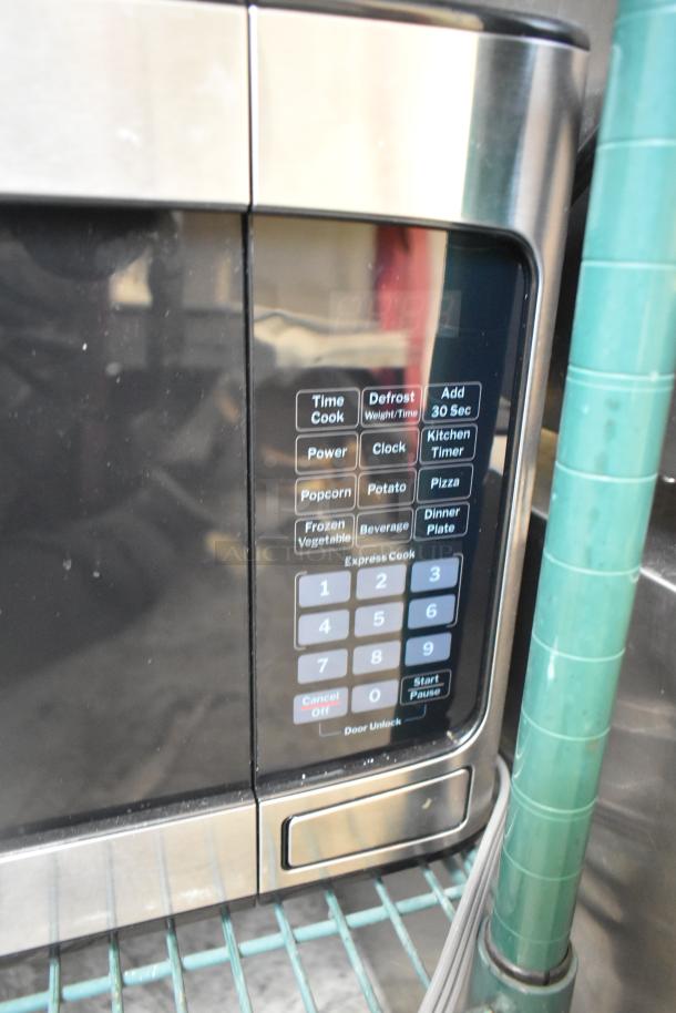 General Electric GE GCST11X1W1SS microwave oven, 120 volts, keypad controls, used condition, includes plate.