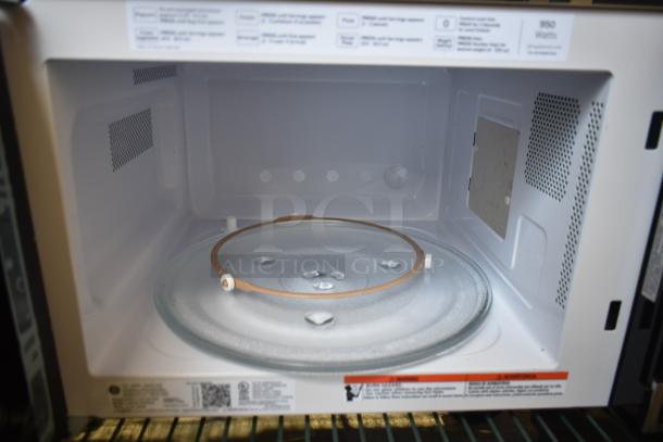 General Electric GE GCST11X1W1SS microwave oven, includes glass plate, 120 volts, 1 phase, tags detail specifications.