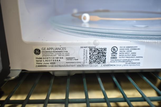 General Electric GE Microwave Oven GCST11X1W1SS with plate, 120 volts, model and safety labels visible.