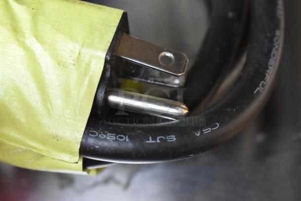 Close-up of a power cord and plug for a 2021 Sharp R-21LVF Commercial Microwave Oven, 120 Volts, 1 Phase.