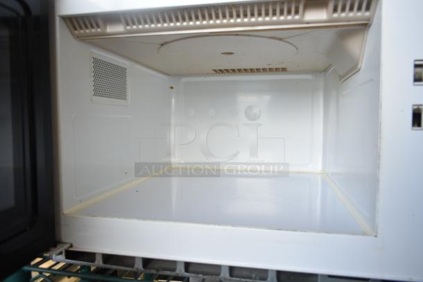 Amana RCS10MPA commercial microwave oven interior, 120 volts, 1 phase, visible vent, stainless steel, some wear.