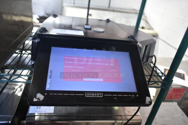 2017 Hobart HTi-7LH26 commercial food scale with digital display, black casing, showing communication error message.