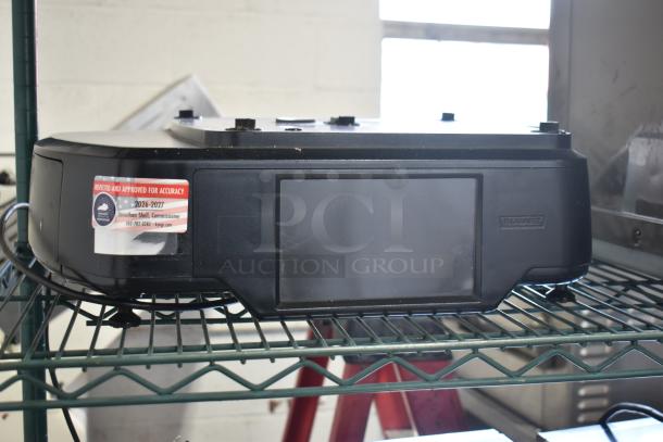 2017 Hobart HTi-7LH26 countertop food portioning scale, black, with inspection label. Operates on 120/208-240 volts, 1 phase.