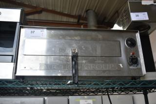 Wisco 560 countertop electric pizza oven, 120 volts, 1 phase. Stainless steel, used condition, with temperature dials.