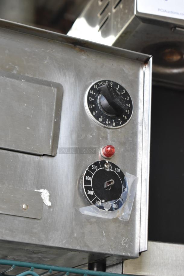 Wisco 560 countertop electric pizza oven, 120V, 1 Phase, with temperature dial. Slight wear visible.