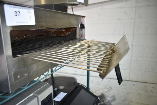 Wisco 560 countertop electric pizza oven, 120 volts, 1 phase, stainless steel, open door showing rack, auction label number 37 visible.