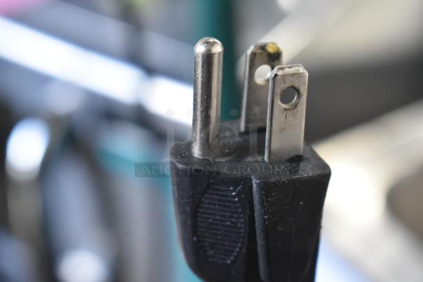 Close-up of a power plug for the Nemco 6055A countertop food warmer, 120 volts, 1 phase, indicating electrical connectivity.