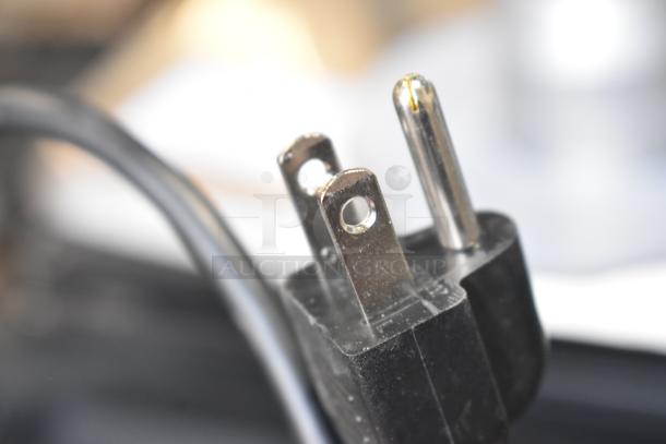 Close-up image of a power plug for the 2025 Hobart HTi-7LH4W Commercial Countertop Food Portioning Scale.