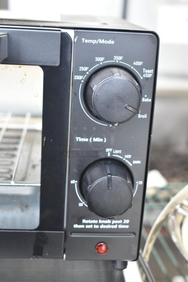 Mainstays MS54100112163 toaster oven with temperature and time controls. Slight wear visible. 120 volts, 1 phase.