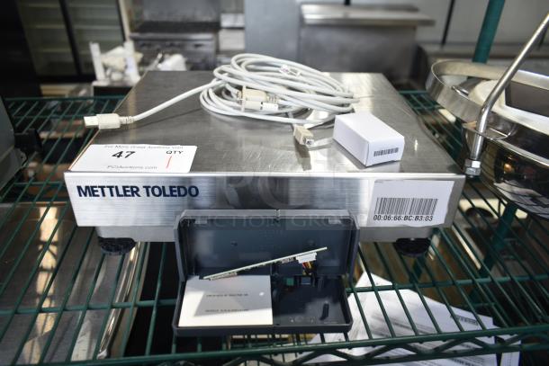 Mettler Toledo BC countertop scale with cables. Stainless steel, barcode visible. Good condition, ideal for commercial use.