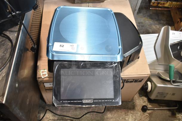2025 Hobart HTi-7LH4W commercial food portioning scale, silver top, touchscreen display, 120/208-240V, 1 phase.