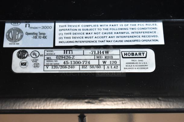 2025 Hobart HTi-7LH4W commercial food portioning scale label showing model, serial number, voltage, and compliance info.