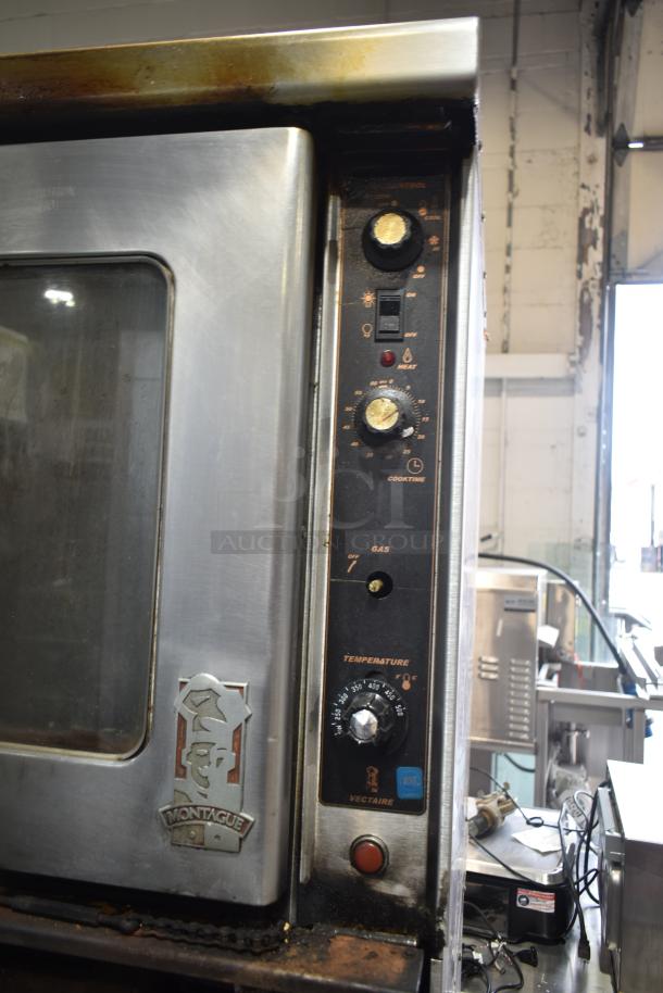 Montague commercial gas convection oven with view-through doors and thermostatic controls, visible wear, model label present.