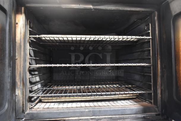 Two Montague commercial gas-powered full-size convection ovens with view-through doors and thermostatic controls, in used condition.