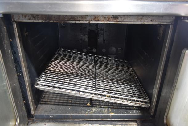 Montague commercial gas convection oven with view-through doors and thermostatic controls. Interior view showing rack and mild wear.